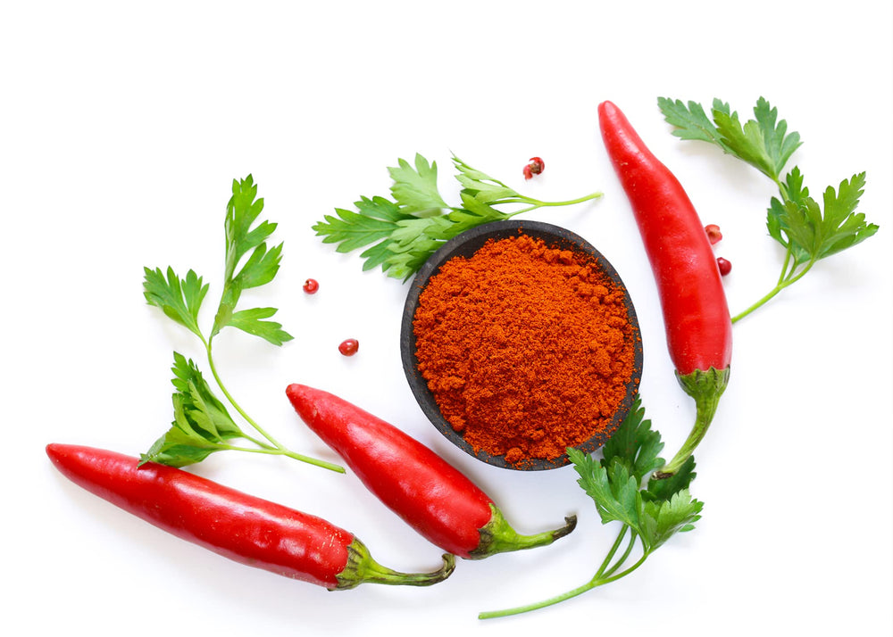 Pouring Unpretentious smoked paprika to finish a dish