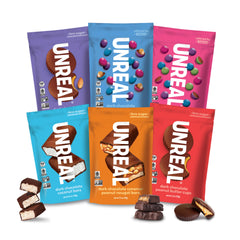 UNREAL Complete Variety Pack peanut butter cups on a colorful counter for energy-friendly snacking.