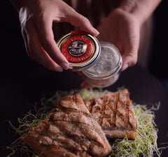 Urbani Truffles white truffle salt jar close-up for aromatic finishing touch.