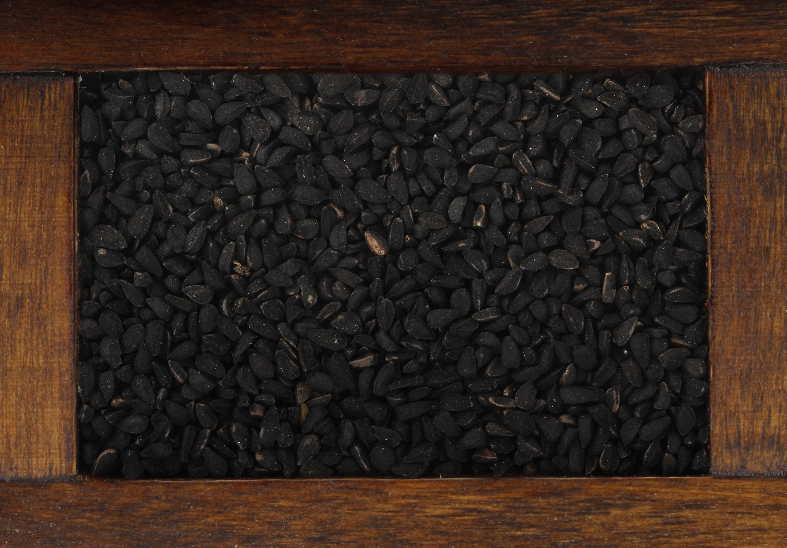 Close-up of rich black cumin seeds showing texture for culinary inspiration.