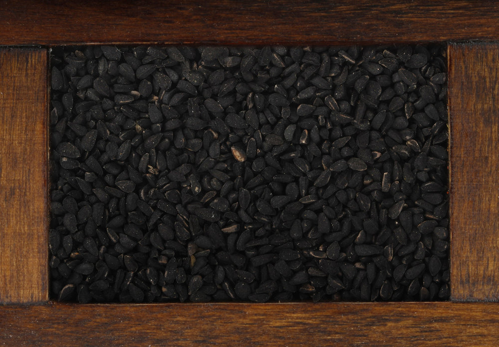 Close-up of rich black cumin seeds showing texture for culinary inspiration.