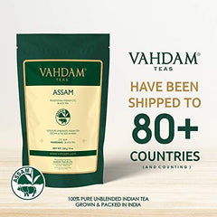 VAHDAM Assam tea being poured into a cup with rich amber color.