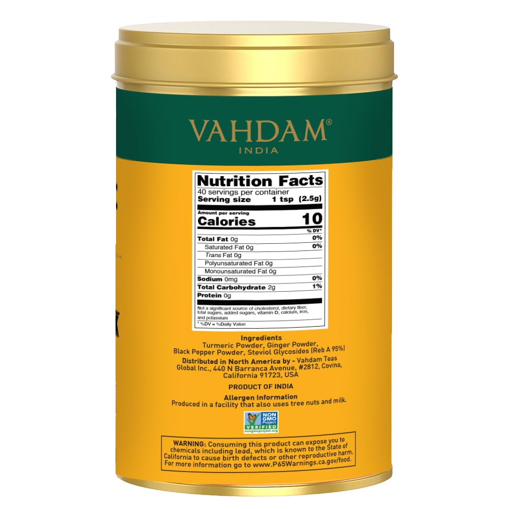 VAHDAM turmeric-ginger latte mix being scooped for a warm cup.