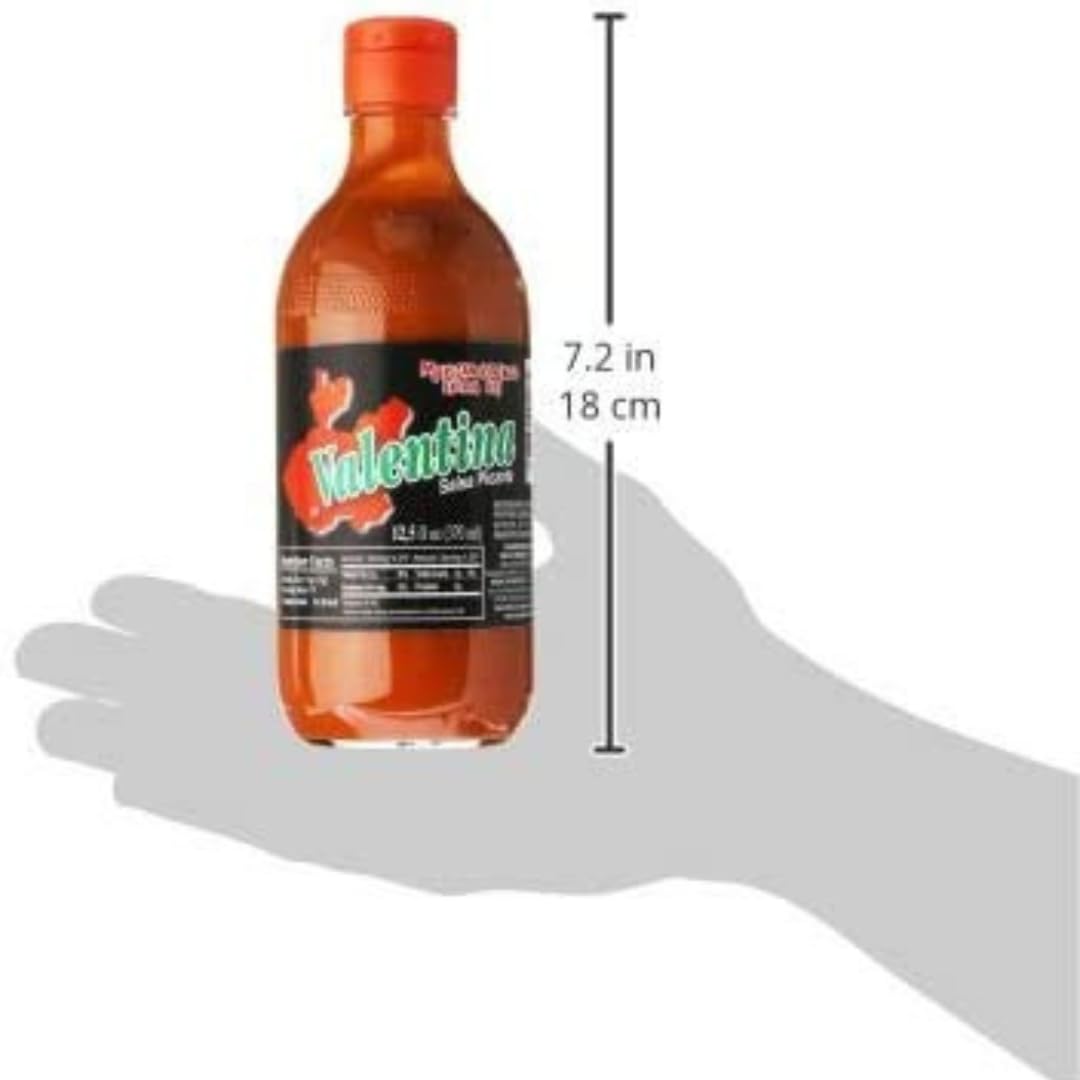Valentina hot sauce on a plate with tacos, enhances flavor.