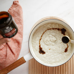 A 2 oz Simply Organic vanilla bean paste bottle on a kitchen counter.