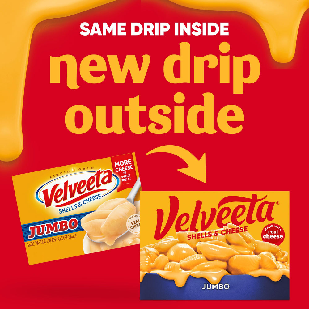 Velveeta creamy cheese sauce being poured over shells.