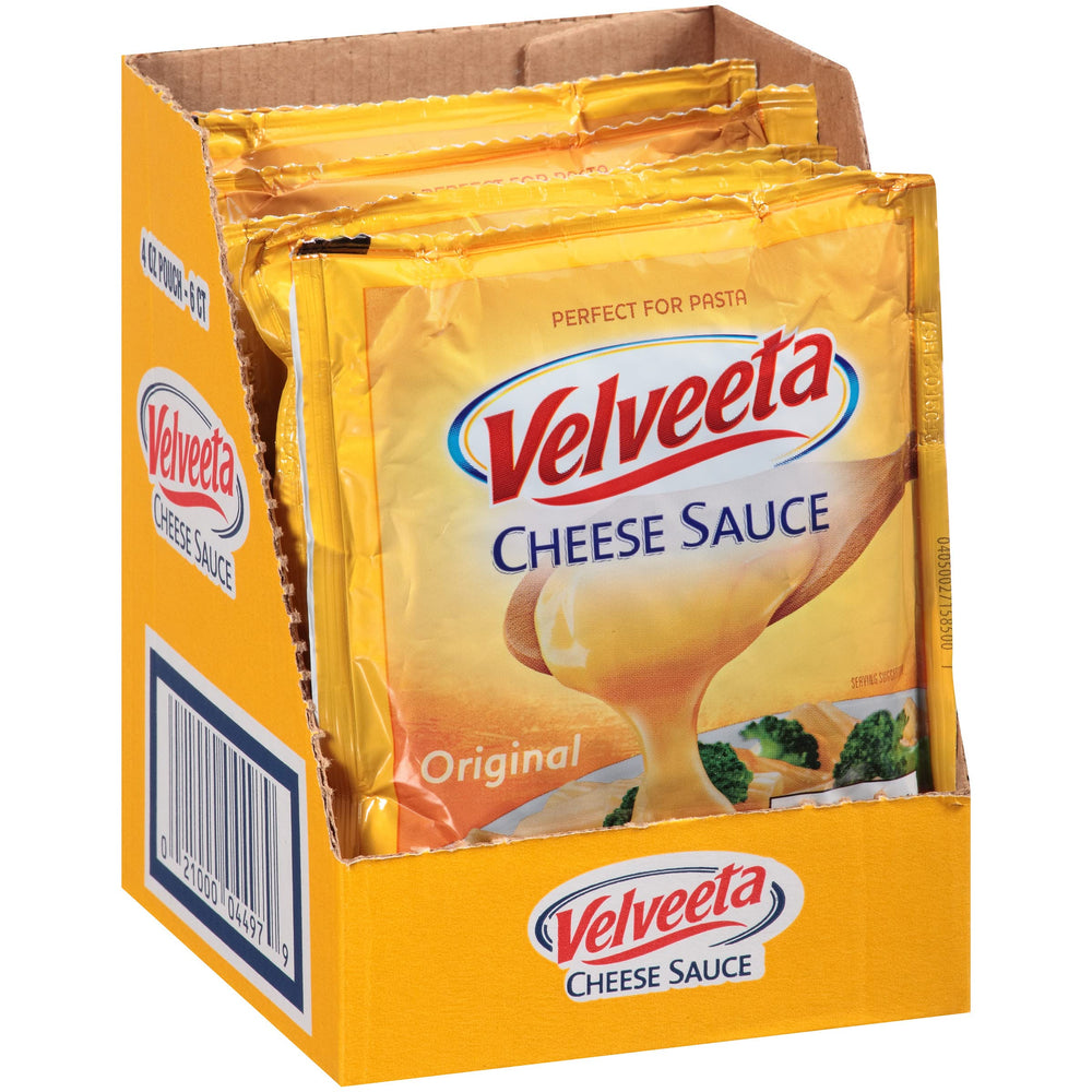 Velveeta Original Cheese Sauce pouches pouring into pan, silky melt enhances nachos and mac.