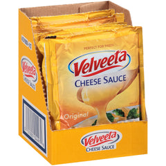 Velveeta Original Cheese Sauce pouches pouring into pan, silky melt enhances nachos and mac.