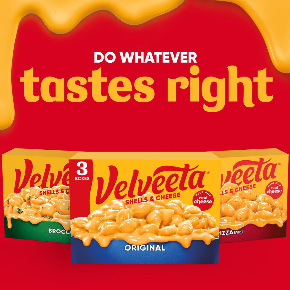 Serving bowls of Velveeta shells and cheese at family table.