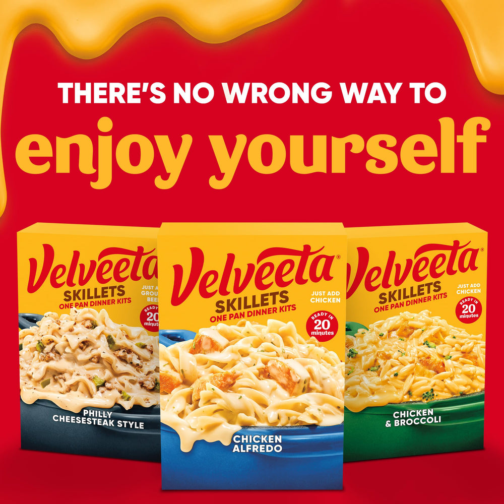 Velveeta Skillets Chicken Alfredo sauce being stirred for a creamy finish.