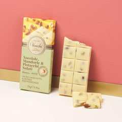 Venchi ingredients close-up: pistachios, hazelnuts, and almonds in premium chocolate.