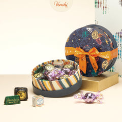 Small blue Venchi hamper on a table, elegant gift ready for anniversaries.