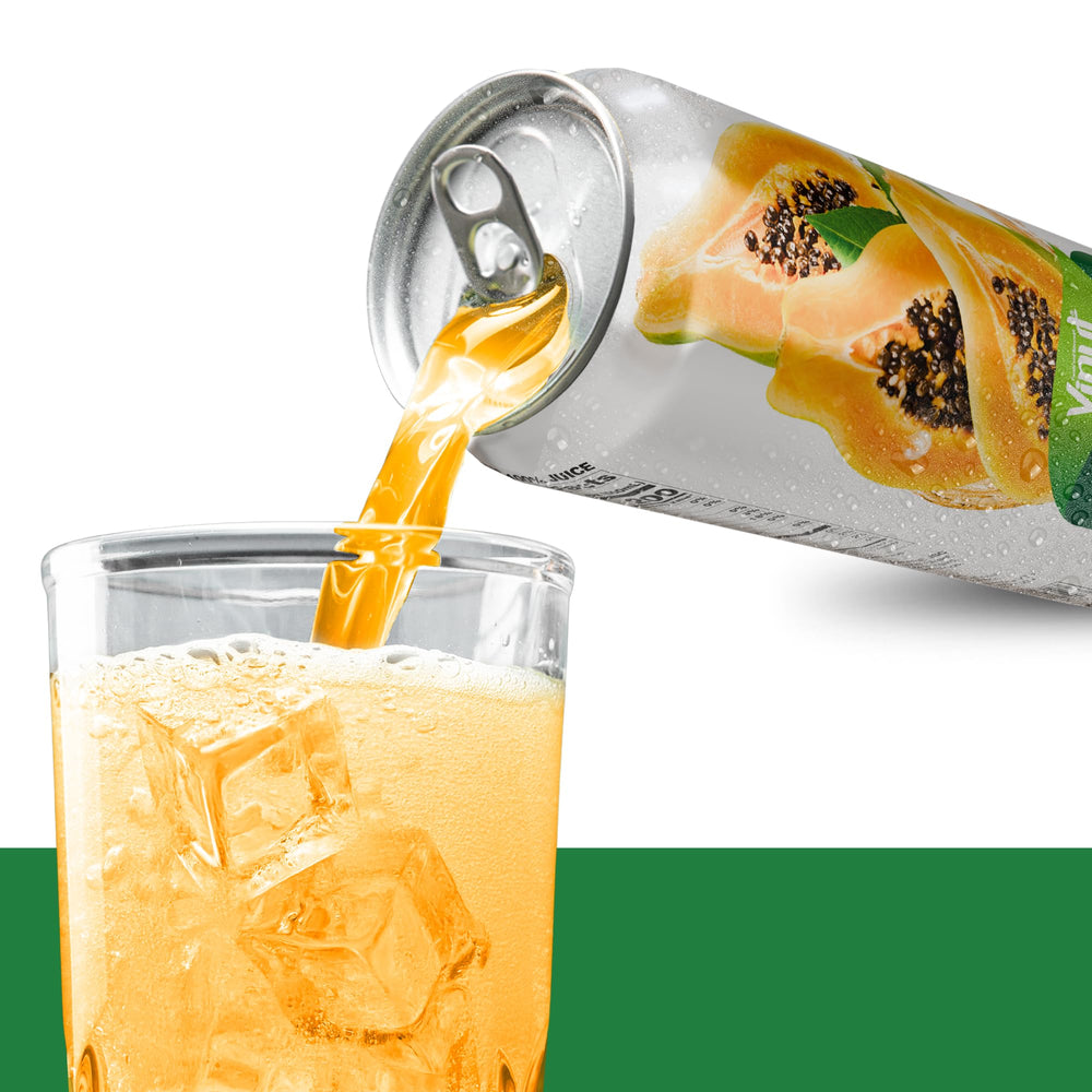 Open glass beside VINUT papaya juice with fresh fruit, breakfast pairing.