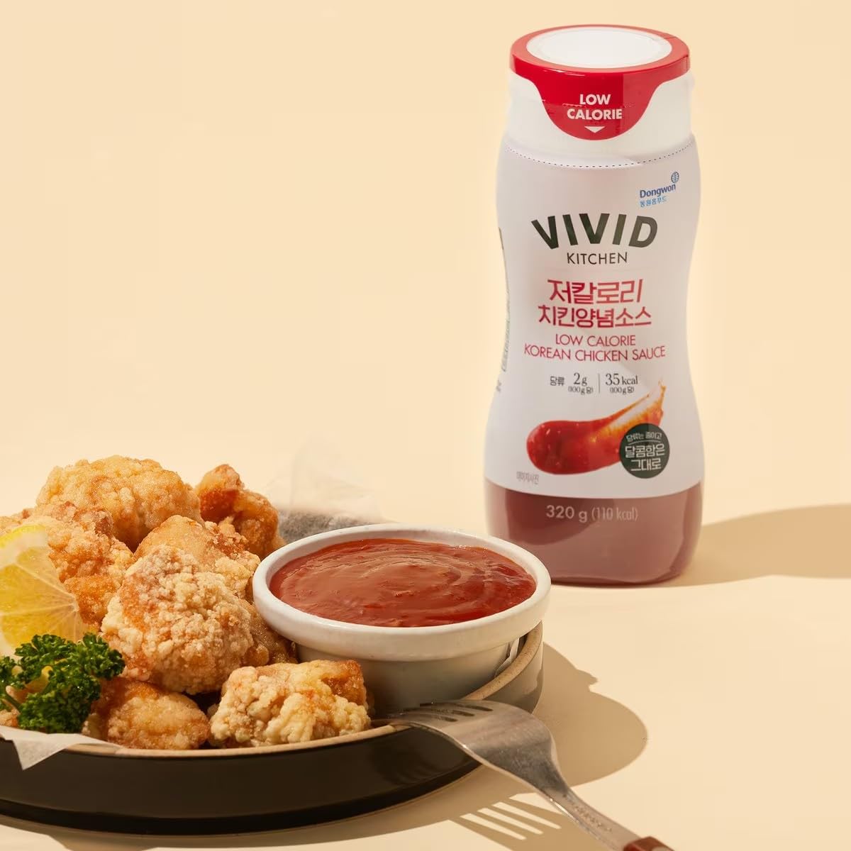 Marinating chicken with VIVID KITCHEN sauce in a glass bowl.