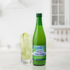 Volcano Juice Lime bottle beside a glass of lime-forward beverage