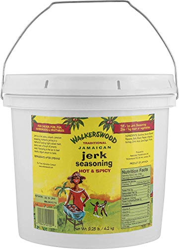 Walkerswood jerk seasoning pour demonstrates fiery heat for meat marination.