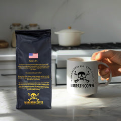 Warpath Coffee light roast ground bag label close-up highlighting dark chocolate notes and Arabica.
