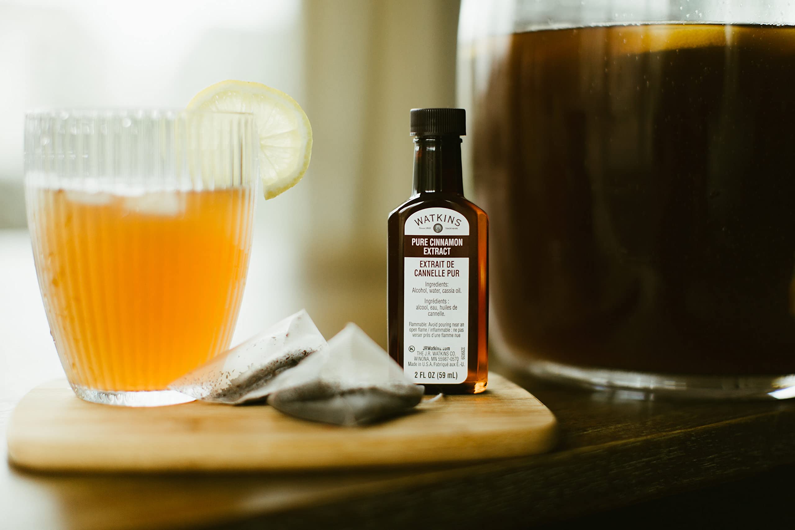 Watkins Pure Cinnamon Extract in a glass jar ready to measure.