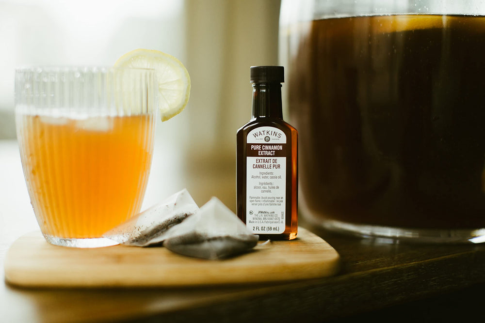 Watkins Pure Cinnamon Extract in a glass jar ready to measure.