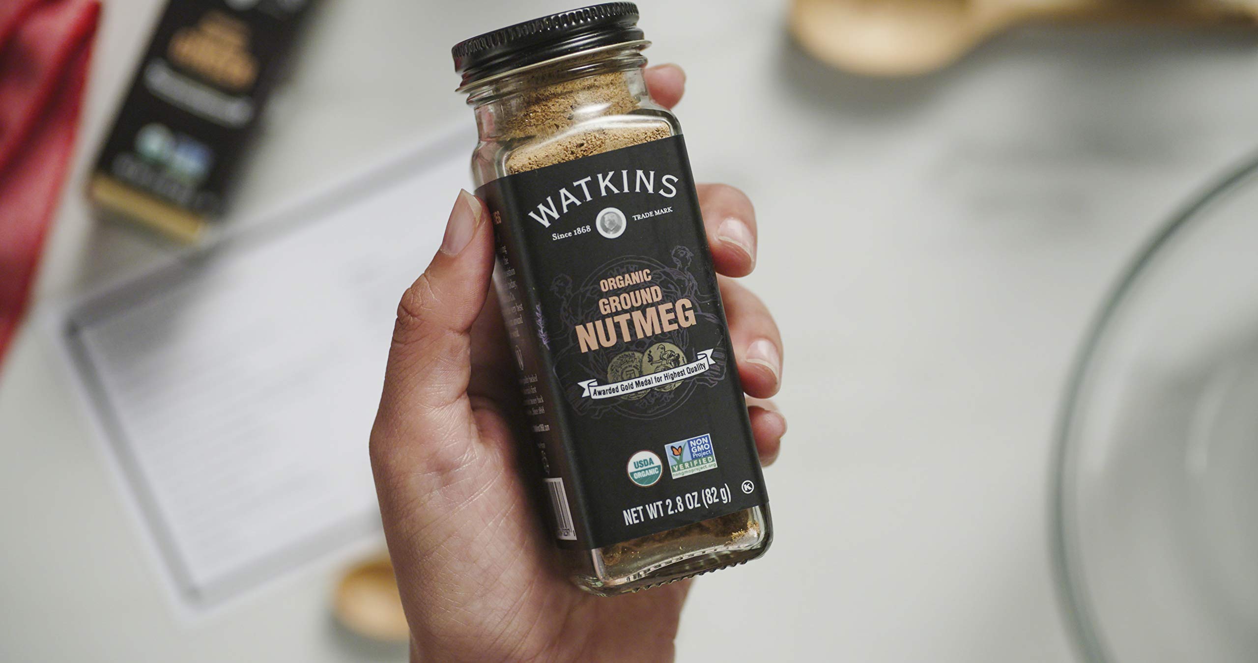 Watkins square glass grinder close up showing premium grinding mechanism.
