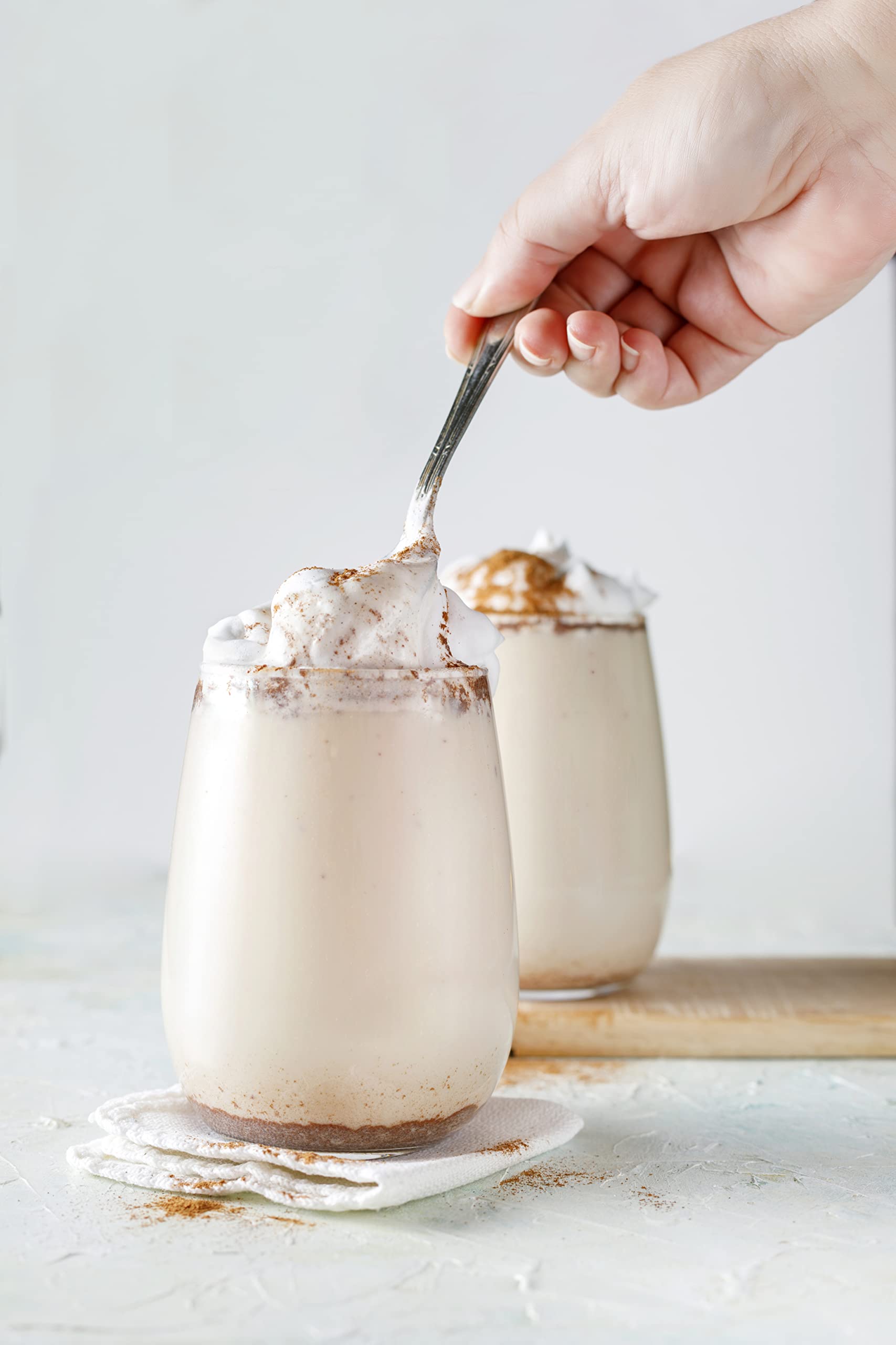 Pouring Watkins vanilla paste showing real vanilla bean specks