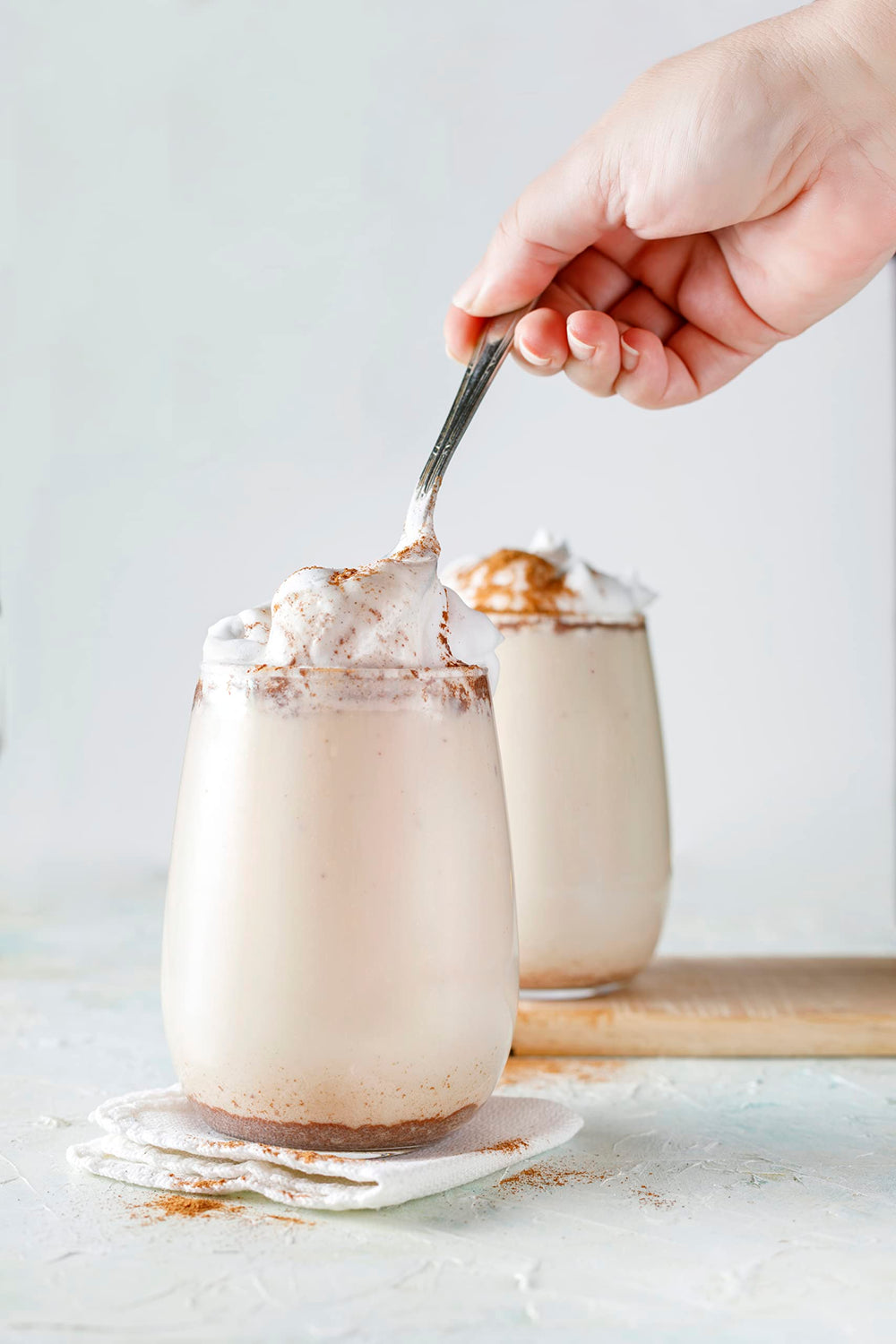 Pouring Watkins vanilla paste showing real vanilla bean specks