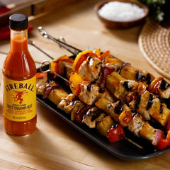 Weber Fireball sauce on a tailgate spread adding smoky sweetness.