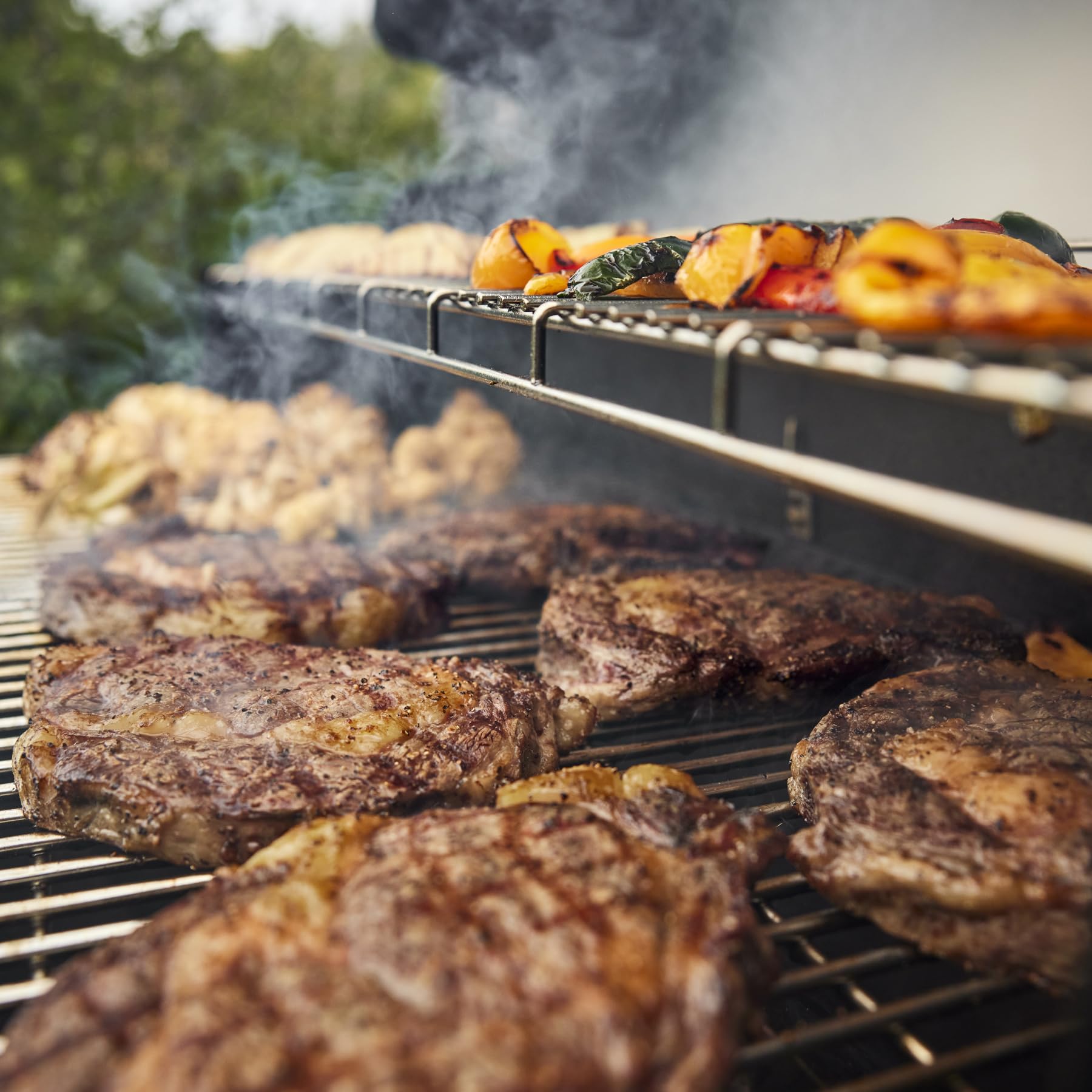 Outdoor grilling scene with Weber Grill'n Spray ready for barbecue