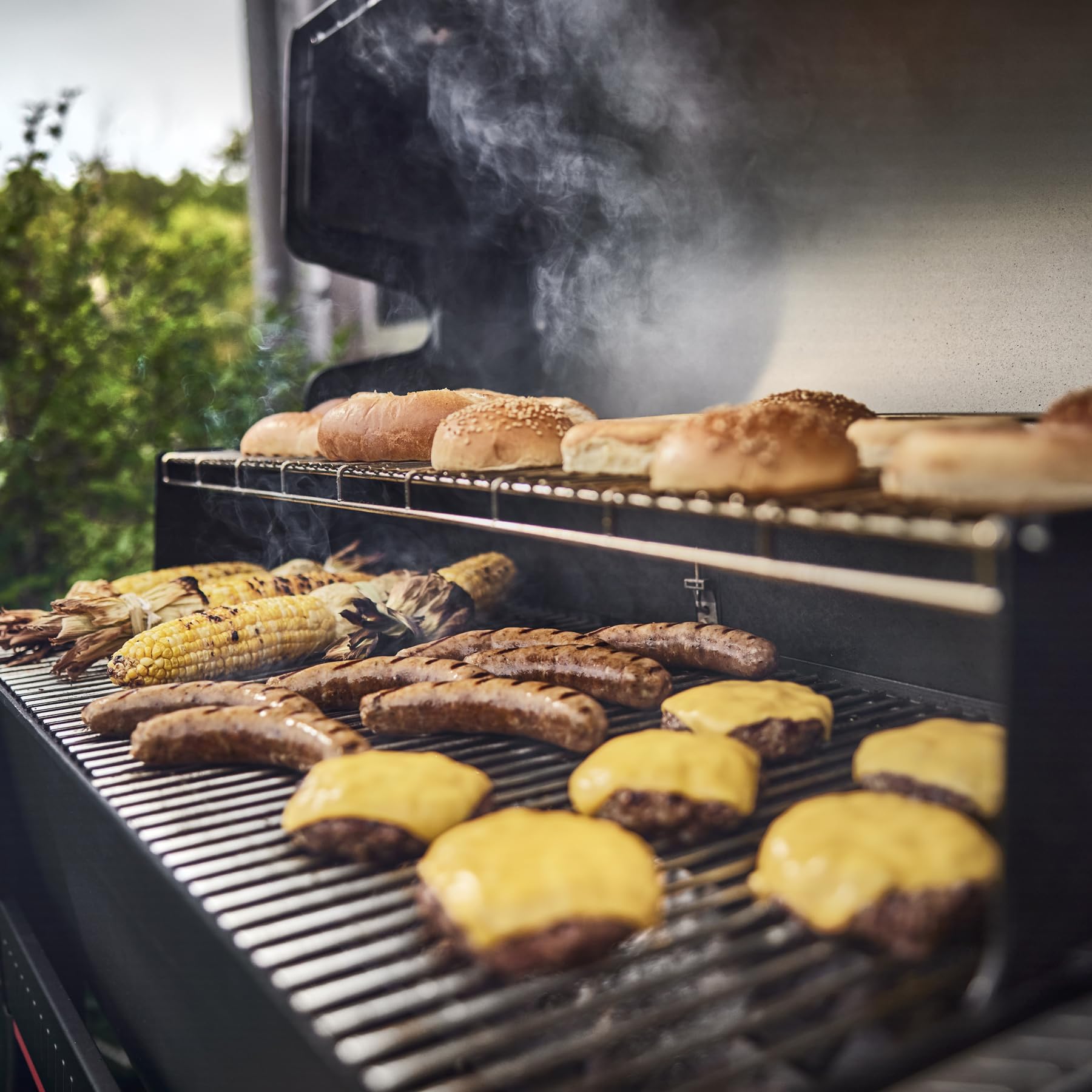 Weber Grill'n Spray beside a grill, highlighting easy cleanup after cooking