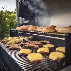 Weber Grill'n Spray beside a grill, highlighting easy cleanup after cooking