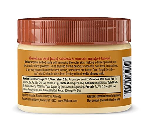Spoon of Wellbee's White Almond Butter showing creamy consistency for smoothies.