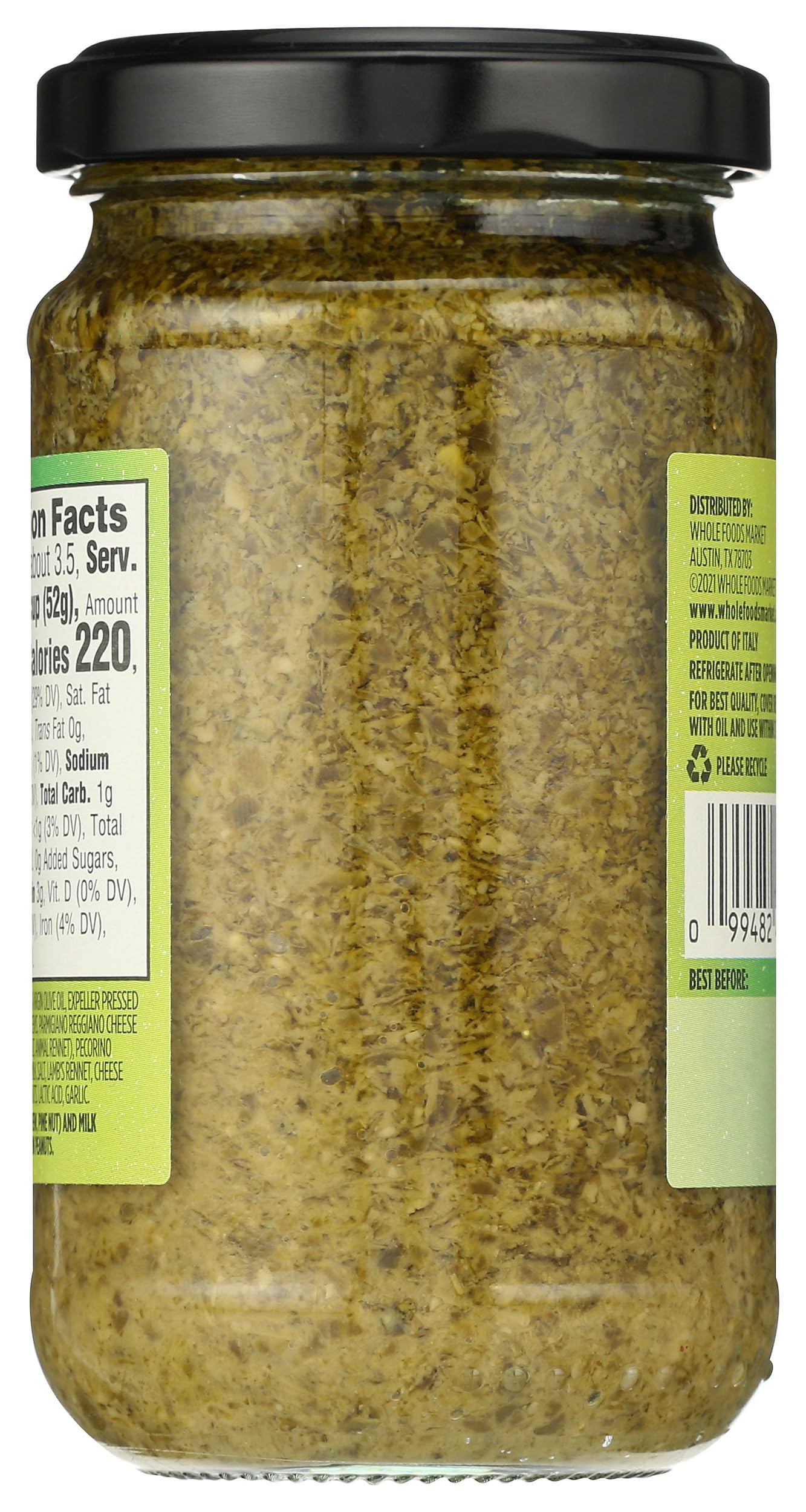 Whole Foods Market Basil Pesto bottle tilted, ready to pour.