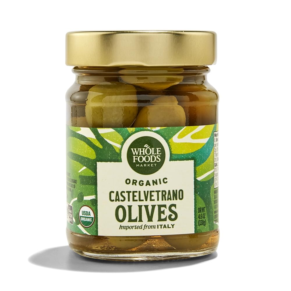 Whole Foods Market Organic Castelvetrano olives in a jar, showcasing vibrant green color and quality packaging.