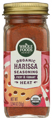 Whole Foods Market organic harissa seasoning in glass jar for flavorful meals.