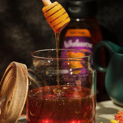 Wholesome honey being poured into dressing for balance.