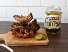Wickles Wicked Pickle Chips beside a sandwich for tangy crunch