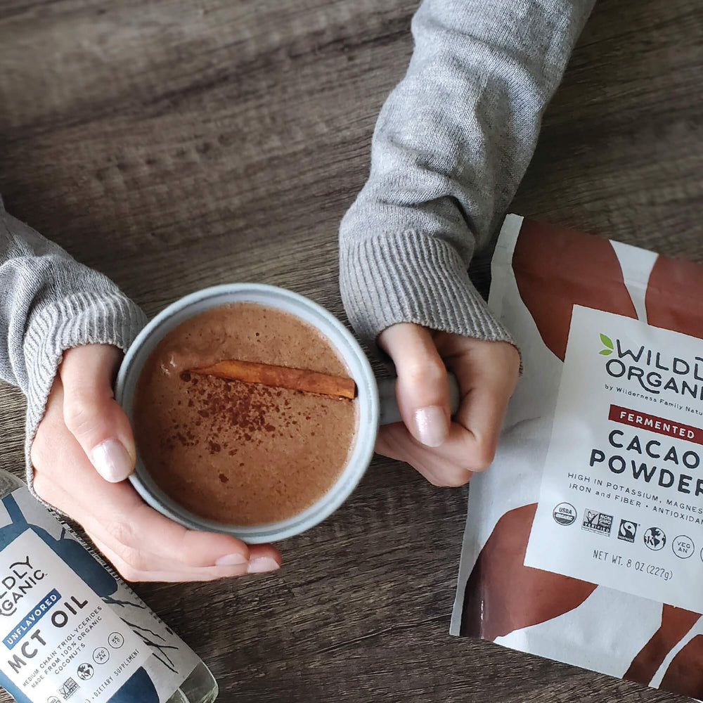 Cacao powder in a glass for a smoothie with Wildly Organic branding