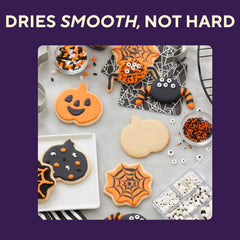 Wilton Black Cookie Icing outlining and piping details on a cookie
