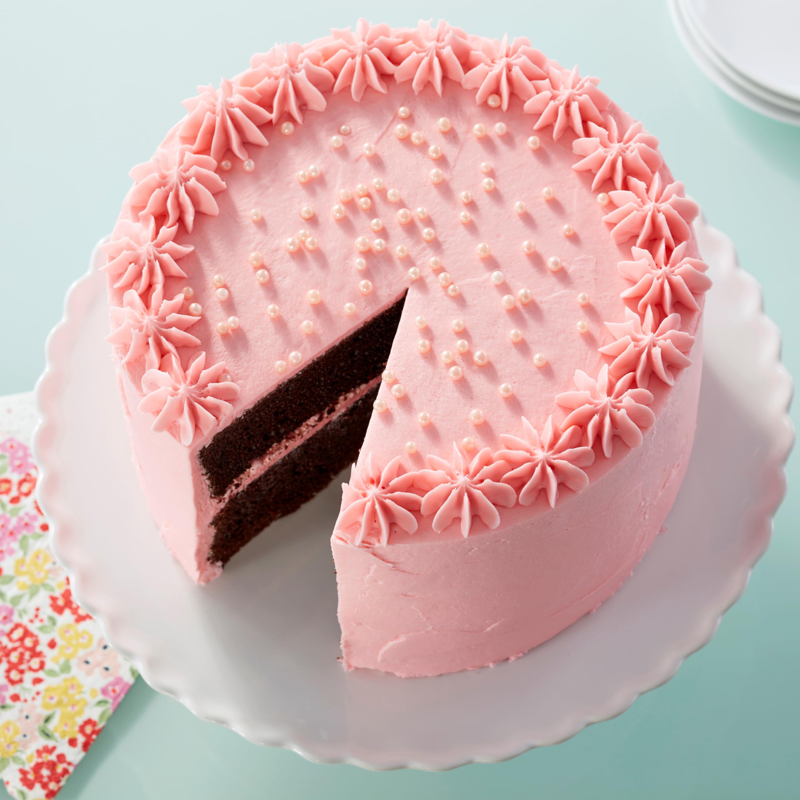 Wilton Pink Sugar Pearls embellish molded candies with glossy pearls.