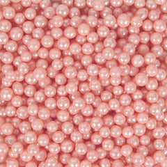 Wilton Pink Sugar Pearls on a cake add refined shimmer and color.