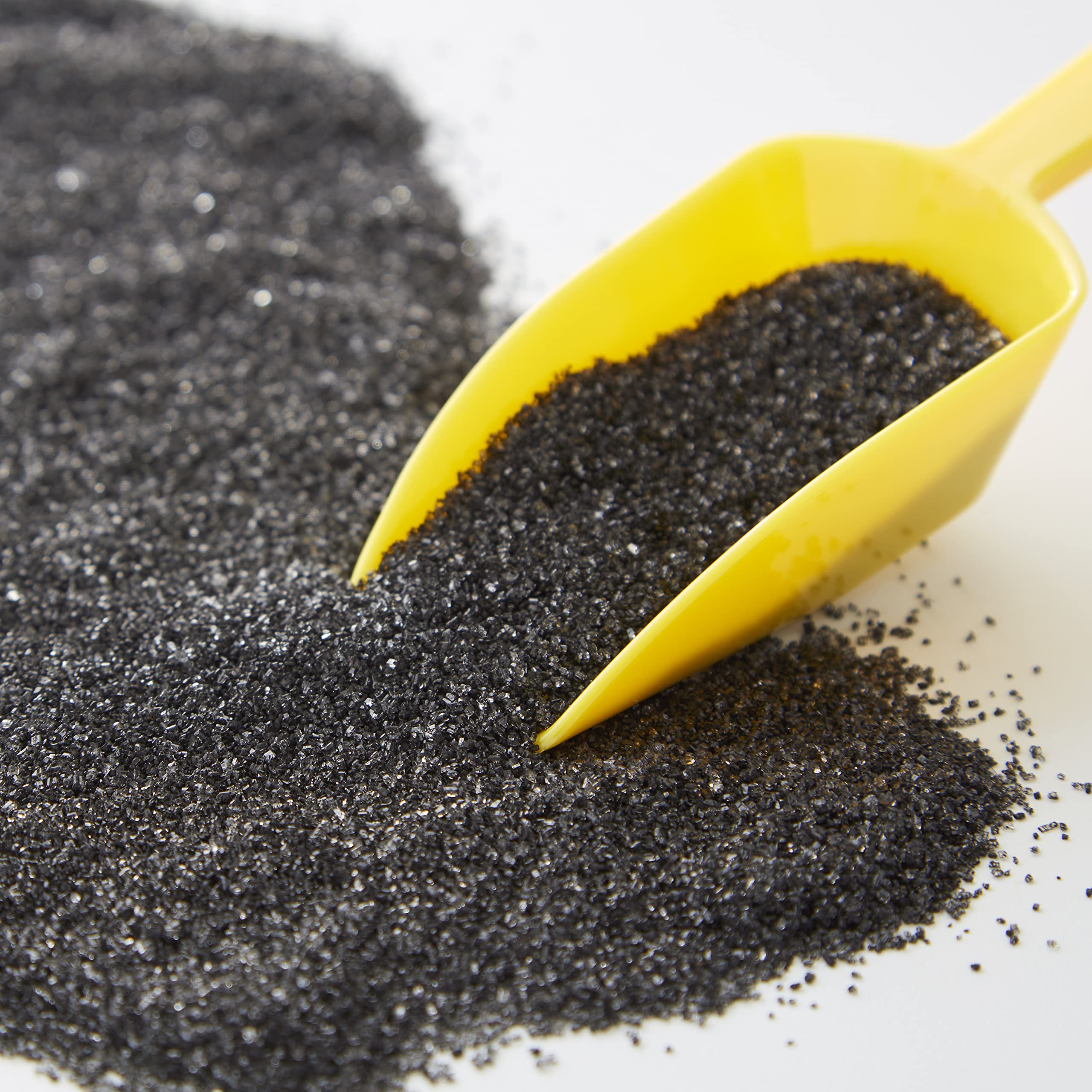Wilton Sparkling Sugar Black being poured for precise sprinkles