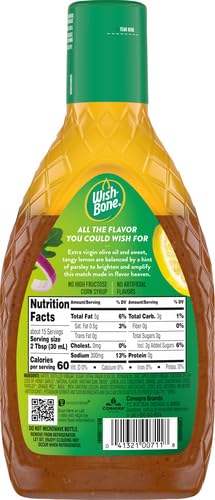 Wish-Bone lemon herb dressing being poured over greens.