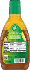 Wish-Bone lemon herb dressing being poured over greens.