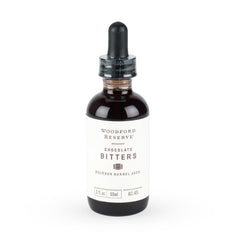 Woodford Reserve Bourbon Barrel Aged Chocolate Bitters bottle pour enhances cocktails with chocolate notes.