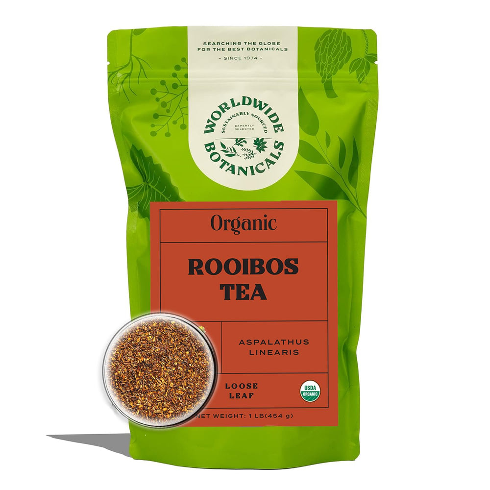 Worldwide Botanicals Rooibos loose leaf tea in a scoop, rich flavor for a comforting cup.
