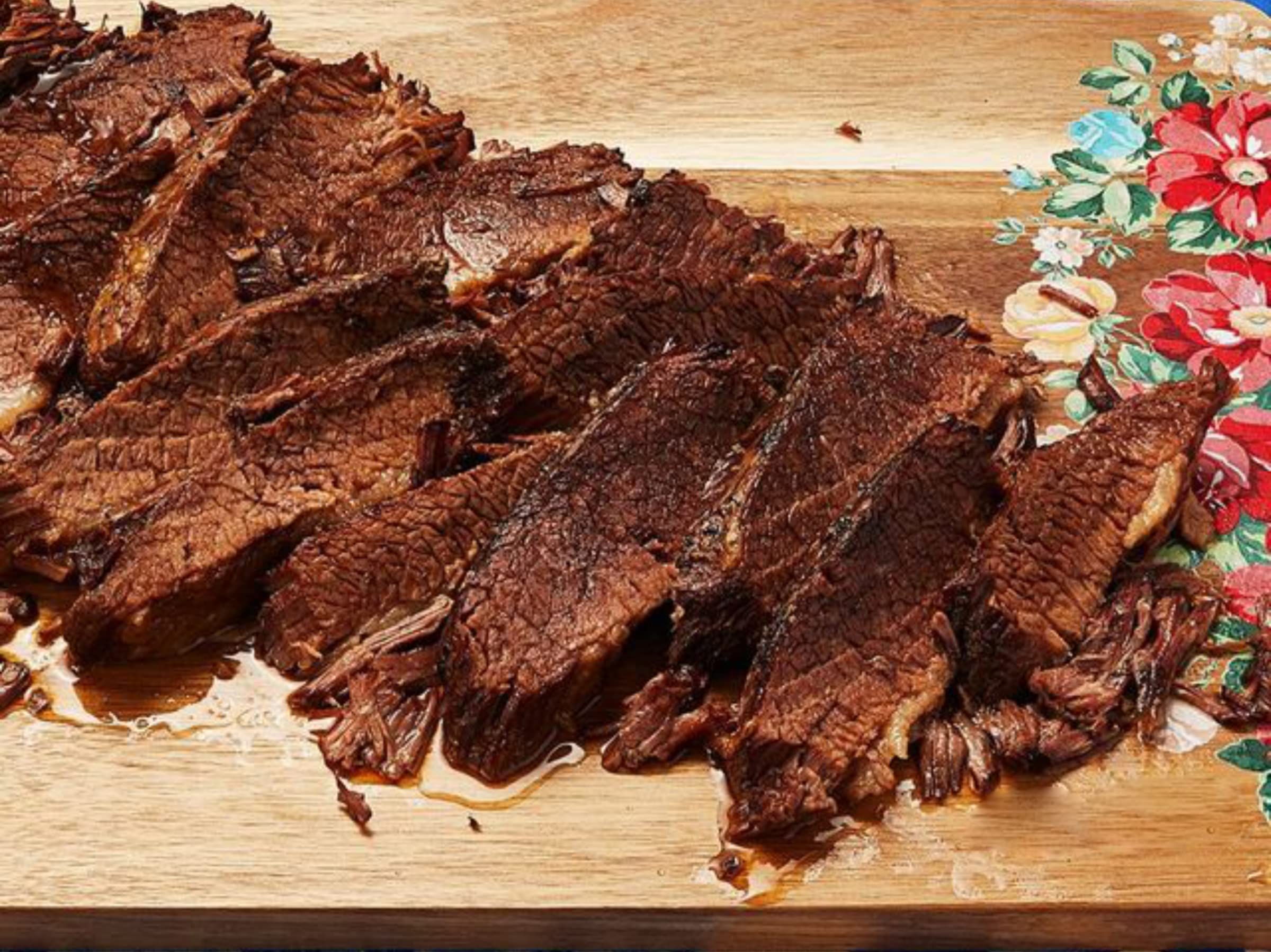 Pouring Wright's Applewood Liquid Smoke to finish ribs
