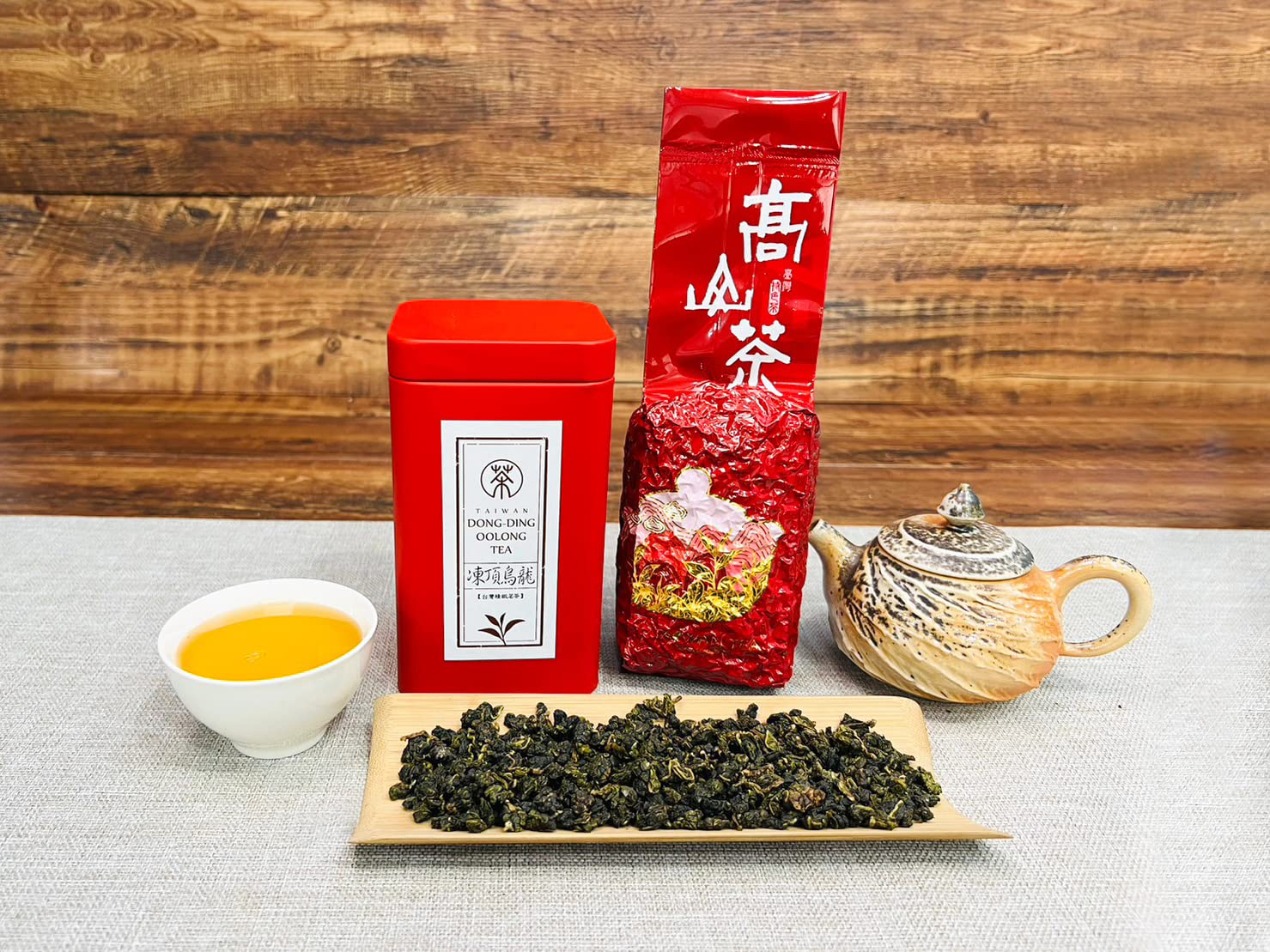 XINQING High Mountain Oolong tea in a cup showing a golden infusion.