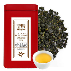 XINQING Taiwan High Mountain Oolong tea leaves in a scoop, fragrant aroma ready to brew.