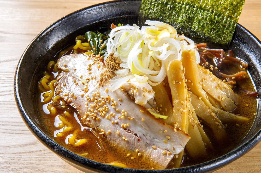 Yamasa shoyu broth bottle with stir fry scene highlights flavor boost.