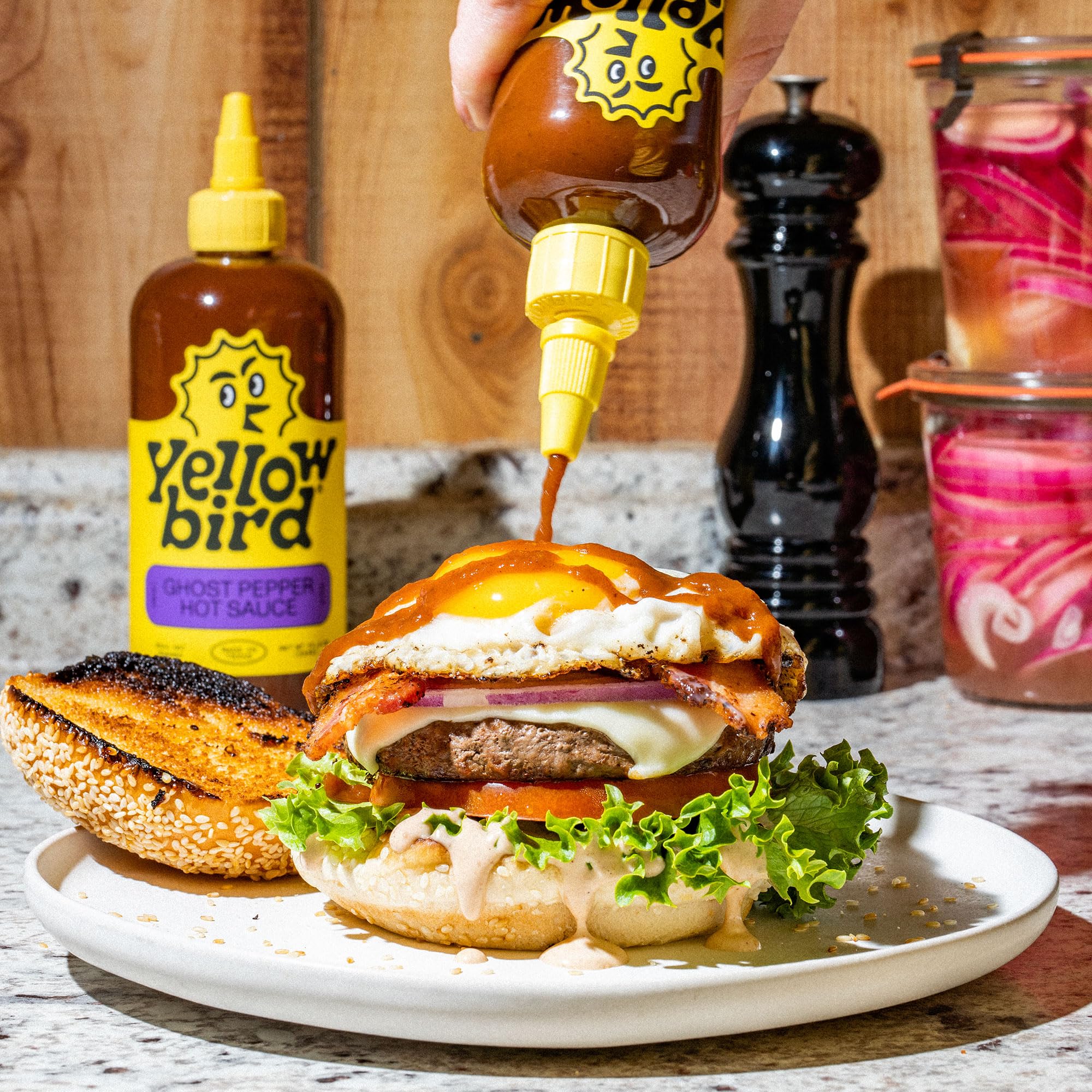 Yellowbird Classic Ghost Pepper hot sauce bottle tilted to reveal label and heat
